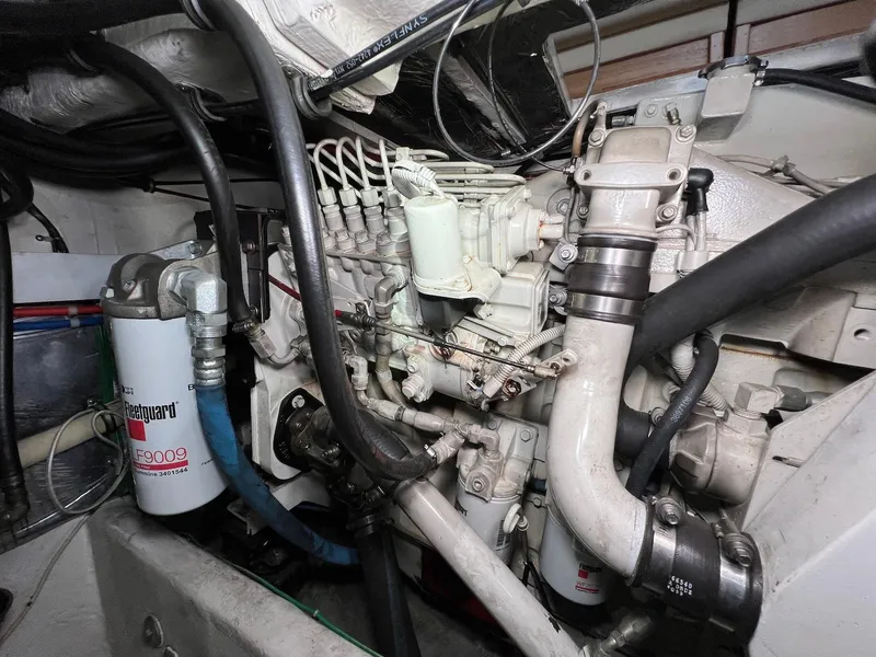 Slide: The Image of Engine compartment of a 2001 Maxum 4600 SCB boat, showcasing mechanical components and filters. - 38