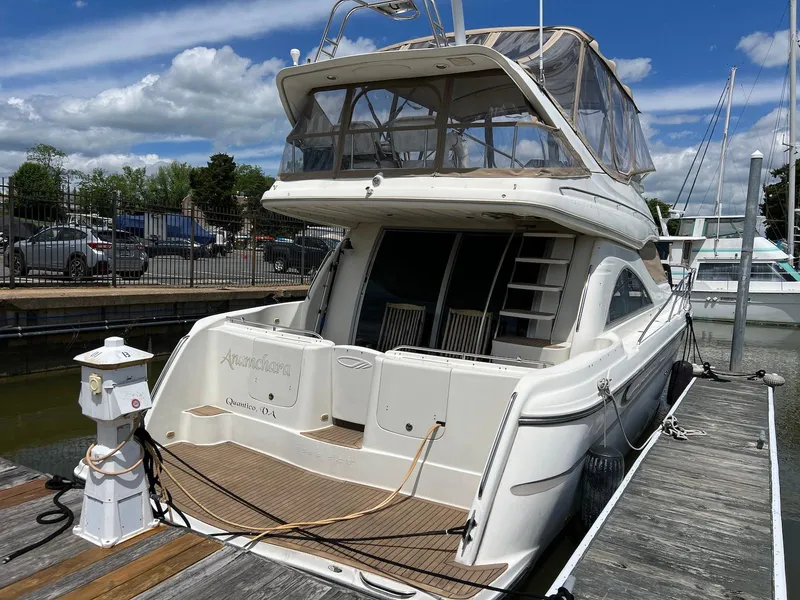 Slide: The Image of 2001 Maxum 4600 SCB yacht docked at marina under blue sky. - 4