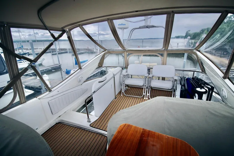 Slide: The Image of 2001 Maxum 4600 SCB yacht interior with seating and marina view. - 7