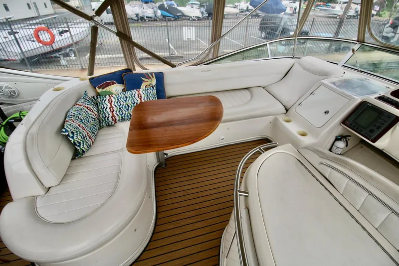 Slide: The Image of 2001 Maxum 4600 SCB yacht interior with white seating and wooden table. - 8
