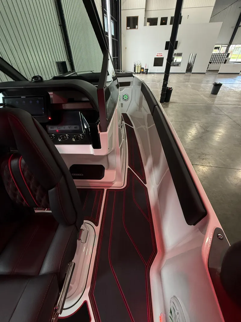 Slide: The Image of 2025 Monterey Elite 27 OB boat interior with sleek design and ambient lighting. - 10