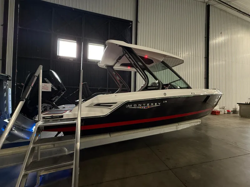 Slide: The Image of 2025 Monterey Elite 27 OB boat in a warehouse setting. - 3