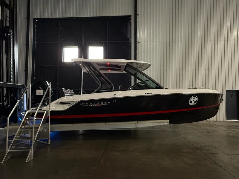 Slide: The Image of 2025 Monterey Elite 27 OB boat in a warehouse, side view with sleek design. - 4