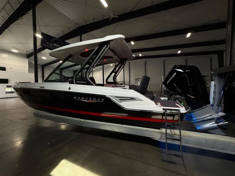Slide: The Image of 2025 Monterey Elite 27 OB boat in showroom, featuring sleek design and modern outboard motor. - 5