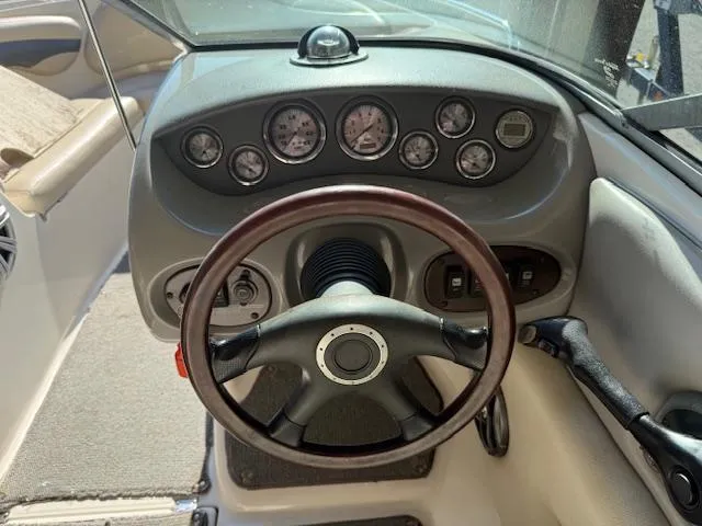 Slide: The Image of Dashboard of a 2004 Chaparral 210 SSi boat with steering wheel and gauges. - 10