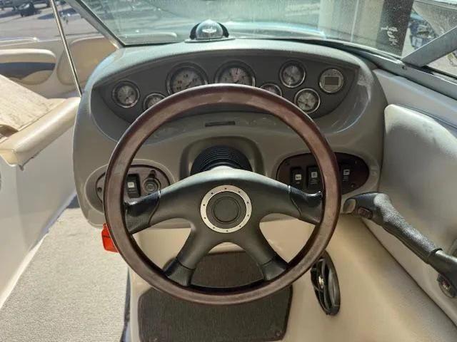 Slide: The Image of 2004 Chaparral 210 SSi boat dashboard with steering wheel and gauges. - 11