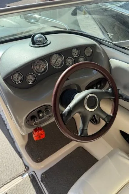 Slide: The Image of 2004 Chaparral 210 SSi boat dashboard with gauges and steering wheel. - 12