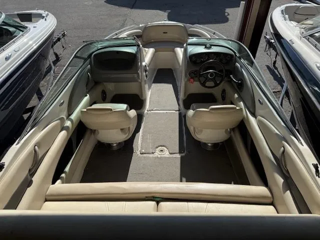 Slide: The Image of 2004 Chaparral 210 SSi boat interior with beige seating and steering console. - 17