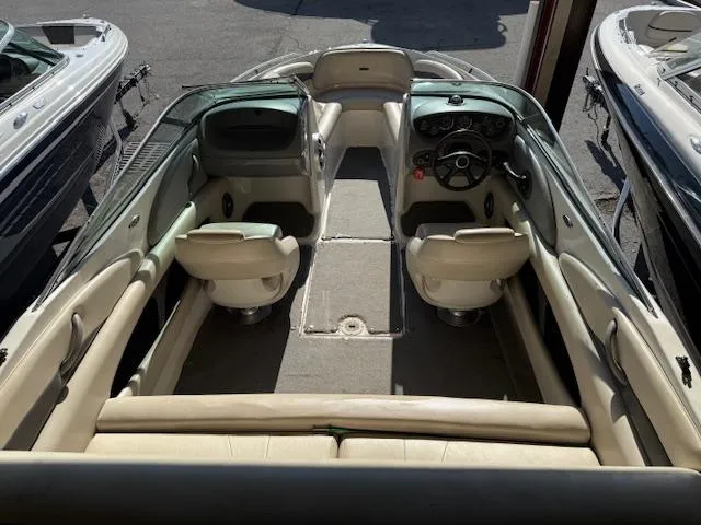 Slide: The Image of 2004 Chaparral 210 SSi boat interior with beige seating and steering console. - 18