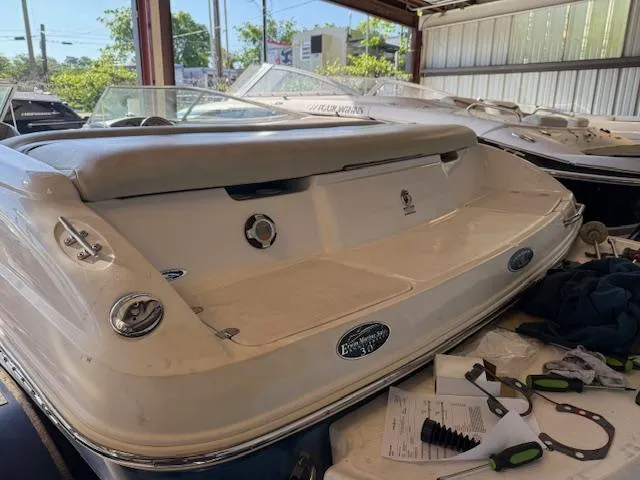 Slide: The Image of 2004 Chaparral 210 SSi boat in storage, rear view with equipment nearby. - 19