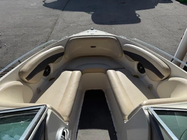 Slide: The Image of 2004 Chaparral 210 SSi boat interior with beige seating and open bow design. - 2