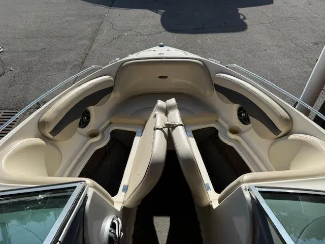 Slide: The Image of 2004 Chaparral 210 SSi boat interior with beige seating and cup holders. - 3