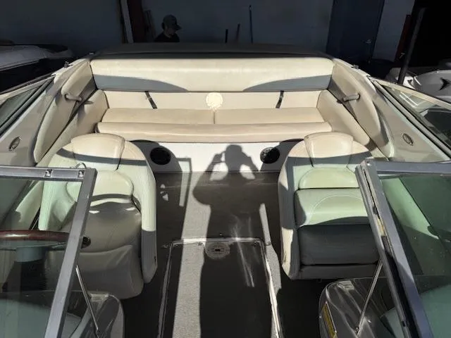 Slide: The Image of 2004 Chaparral 210 SSi boat interior with beige seating and glass windshields. - 4