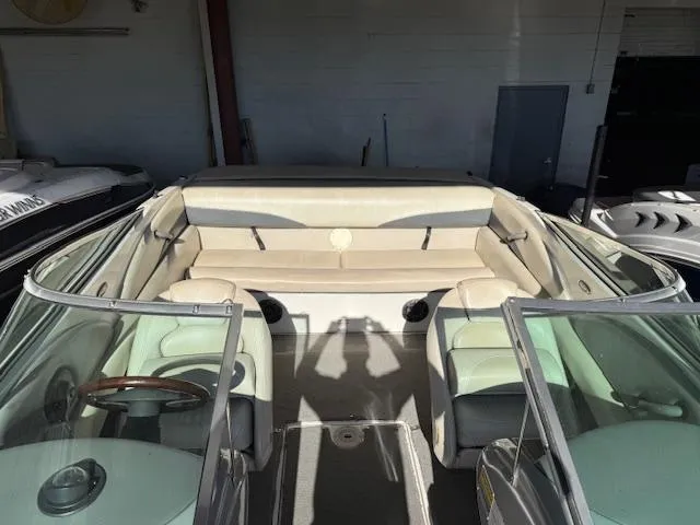 Slide: The Image of 2004 Chaparral 210 SSi boat interior with beige seating and glass windshield. - 5