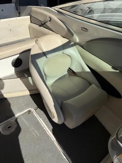 Slide: The Image of 2004 Chaparral 210 SSi boat interior with beige seating and carpeted flooring. - 6