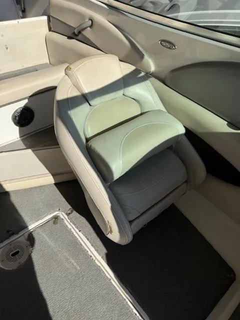 Slide: The Image of 2004 Chaparral 210 SSi boat interior with beige seating and carpeted flooring. - 7
