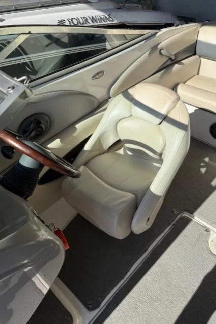 Slide: The Image of 2004 Chaparral 210 SSi boat interior with beige seating and steering wheel. - 8