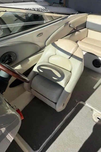 Slide: The Image of 2004 Chaparral 210 SSi boat interior with beige seating and steering wheel. - 9
