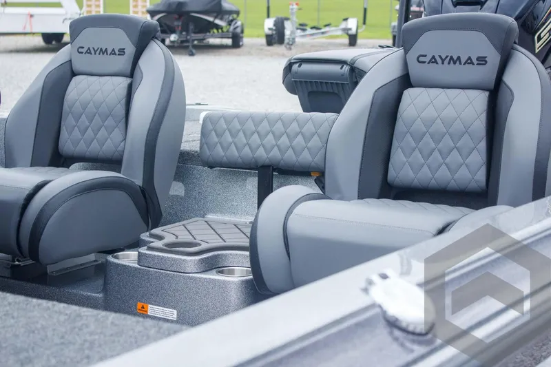 Slide: The Image of 2025 Caymas CX 21 PRO boat interior with gray diamond-stitched seats and modern design. - 21