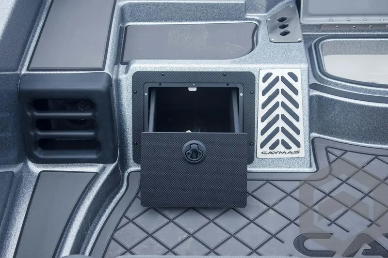 Slide: The Image of 2025 Caymas CX 21 PRO boat interior with storage compartment and textured flooring. - 25