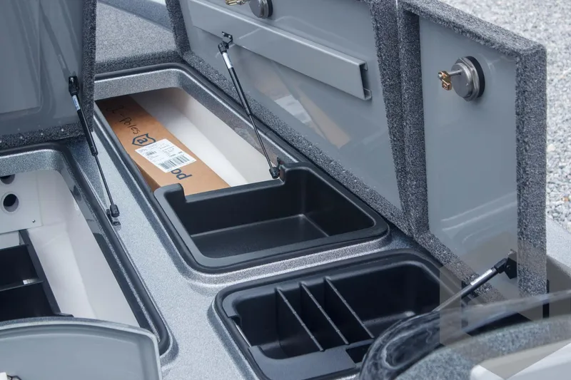 Slide: The Image of 2025 Caymas CX 21 PRO boat storage compartments with open lids and organized interior. - 28