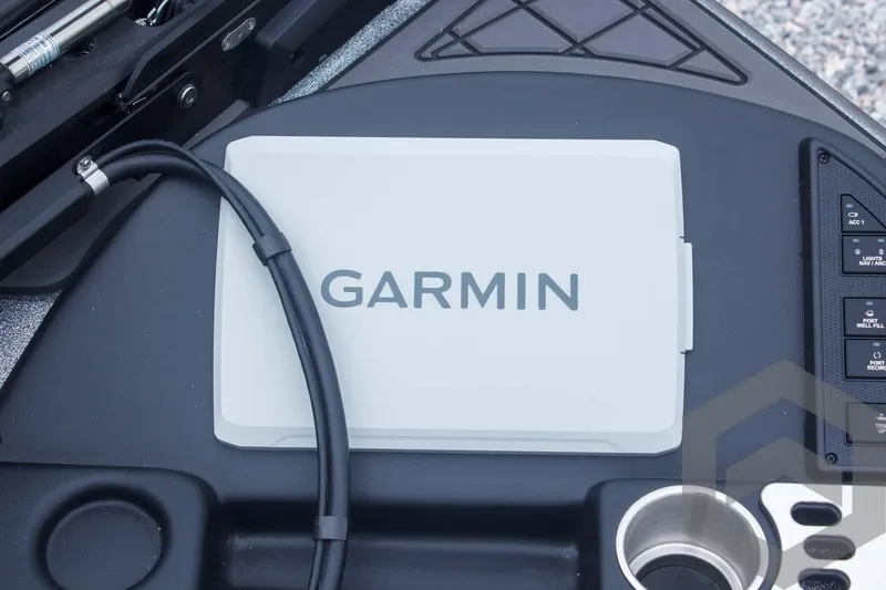 Slide: The Image of Garmin device on 2025 Caymas CX 21 PRO boat dashboard, featuring control panel and cup holder. - 32