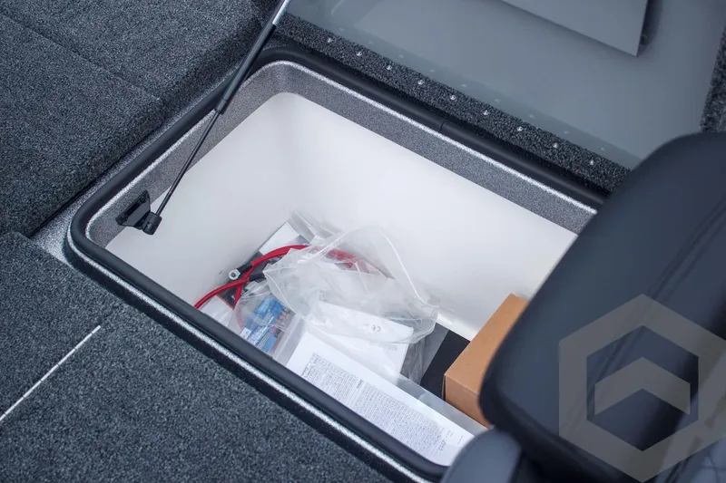Slide: The Image of Storage compartment in 2025 Caymas CX 21 PRO boat, containing various items and accessories. - 48