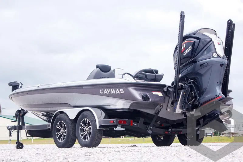 Slide: The Image of 2025 Caymas CX 21 PRO boat with Yamaha engine, parked on gravel. - 7