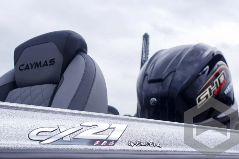 Slide: The Image of 2025 Caymas CX 21 PRO boat interior with branded seat and engine detail. - 9