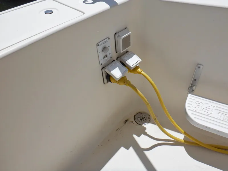Slide: The Image of Electrical outlets and yellow cables on a 2006 Mainship 34 Trawler boat deck. - 21