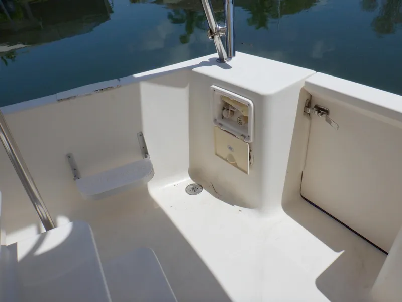 Slide: The Image of 2006 Mainship 34 Trawler cockpit area with seating and storage compartments. - 23