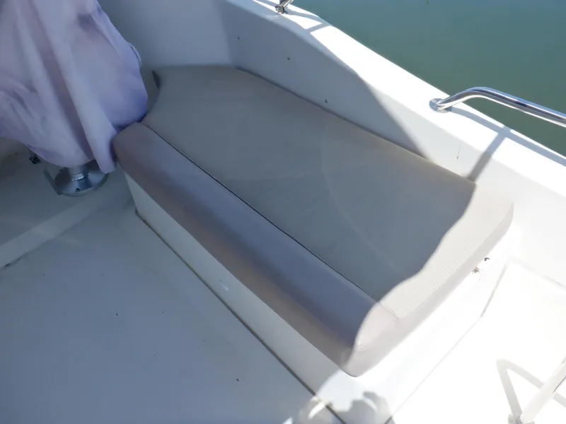 Slide: The Image of 2006 Mainship 34 Trawler bench seat with light gray upholstery. - 25
