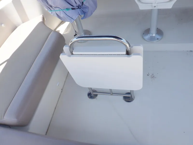 Slide: The Image of Interior of 2006 Mainship 34 Trawler with foldable table and seating area. - 28