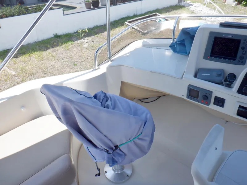 Slide: The Image of 2006 Mainship 34 Trawler helm with covered seat and navigation equipment. - 29