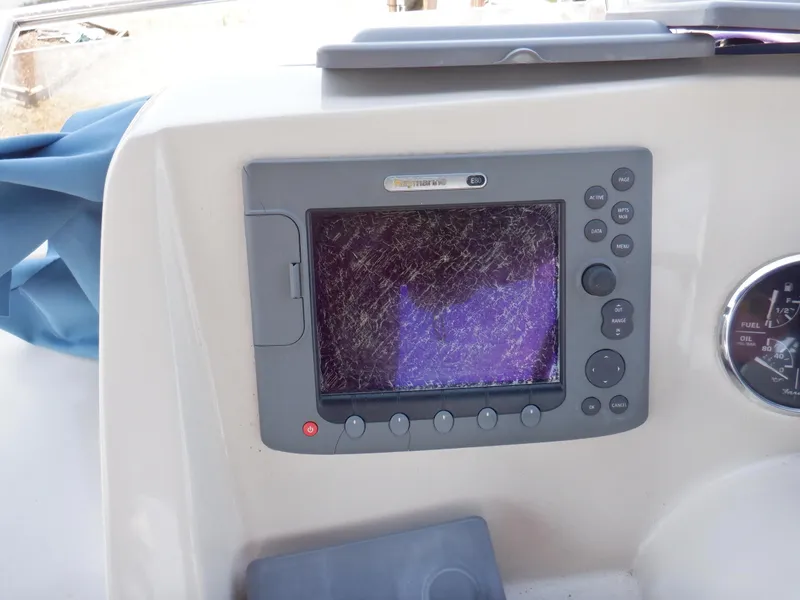 Slide: The Image of Control panel of a 2006 Mainship 34 Trawler with a scratched display screen. - 31