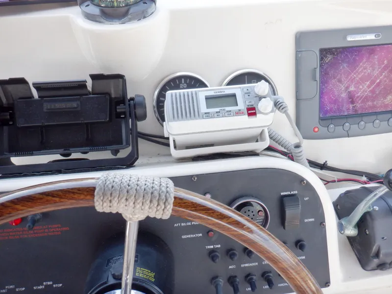Slide: The Image of Control panel of 2006 Mainship 34 Trawler with steering wheel and navigation equipment. - 34