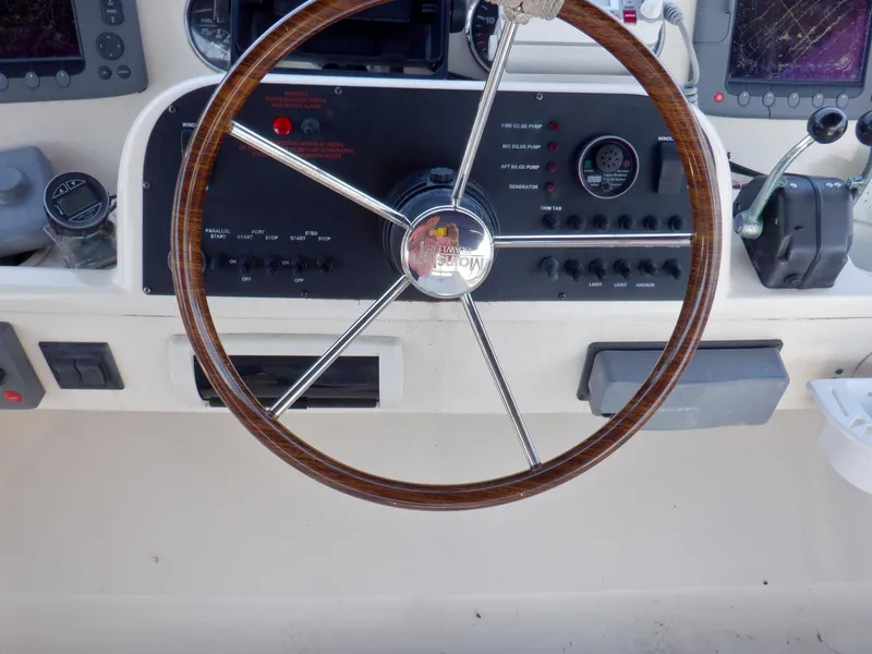 Slide: The Image of Steering wheel of 2006 Mainship 34 Trawler with control panel and navigation instruments. - 35