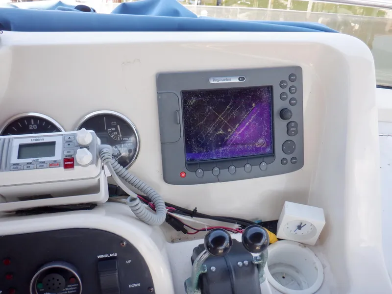 Slide: The Image of Control panel of a 2006 Mainship 34 Trawler with navigation equipment and gauges. - 36