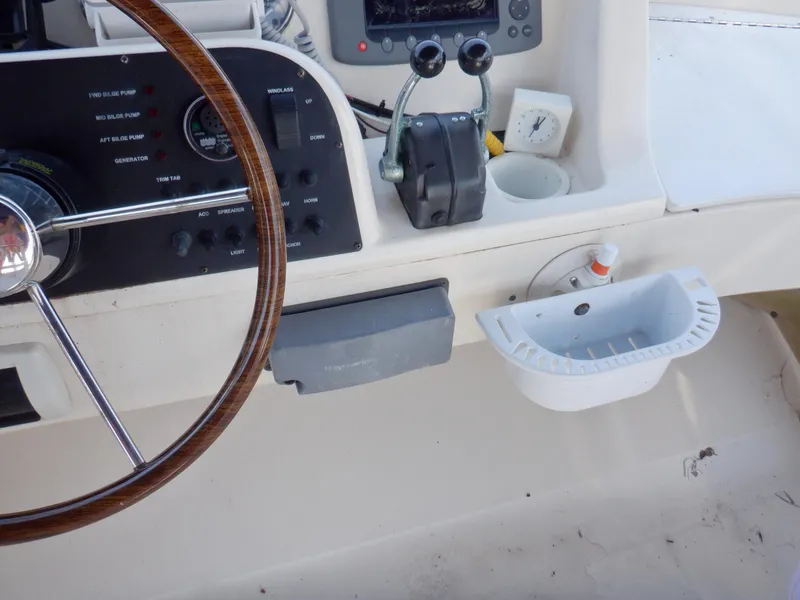 Slide: The Image of 2006 Mainship 34 Trawler helm with steering wheel and control panel. - 37