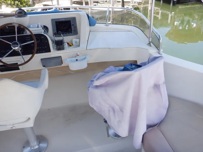 Slide: The Image of Helm of 2006 Mainship 34 Trawler with covered seat and navigation equipment. - 38