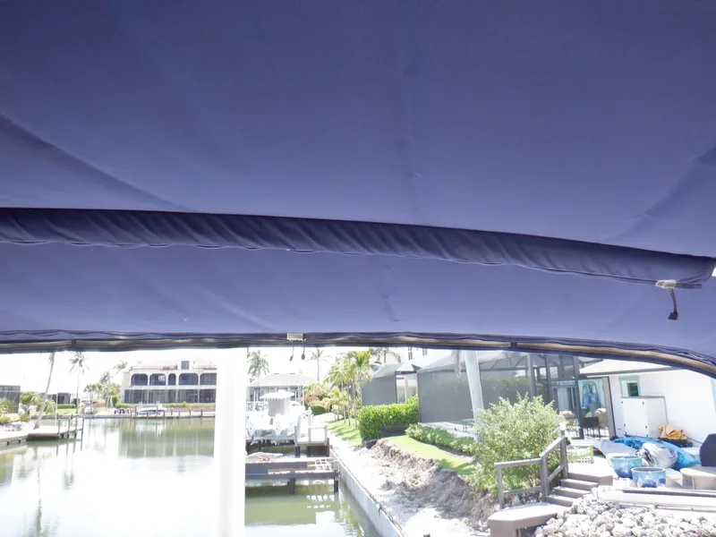 Slide: The Image of 2006 Mainship 34 Trawler canopy view with waterfront background. - 40