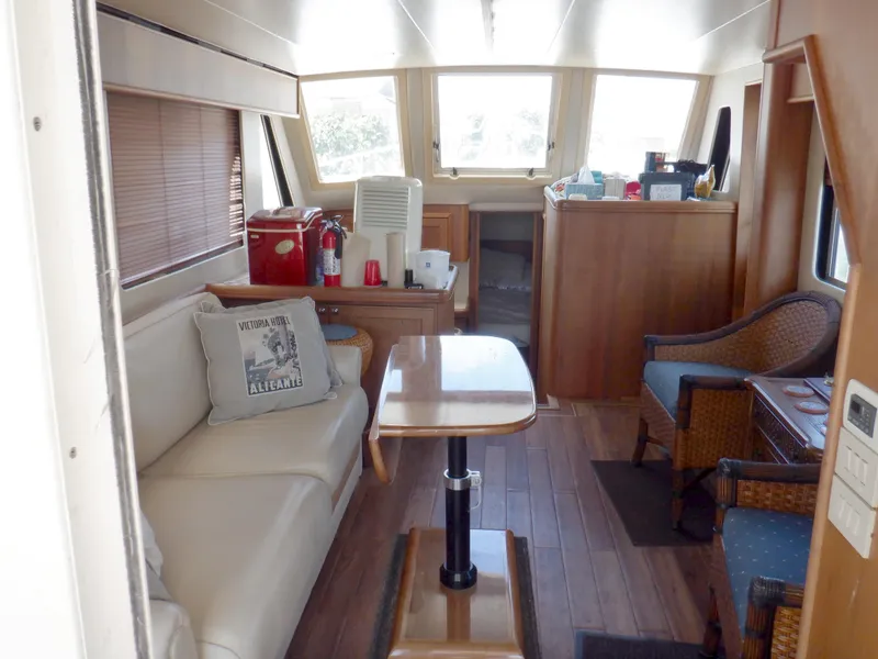 Slide: The Image of Interior of 2006 Mainship 34 Trawler with cozy seating and wooden accents. - 47