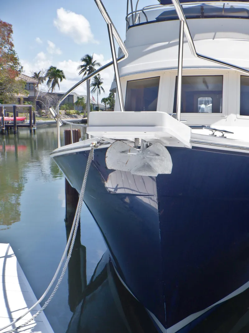 Slide: The Image of 2006 Mainship 34 Trawler docked, featuring sleek design and calm waters. - 8