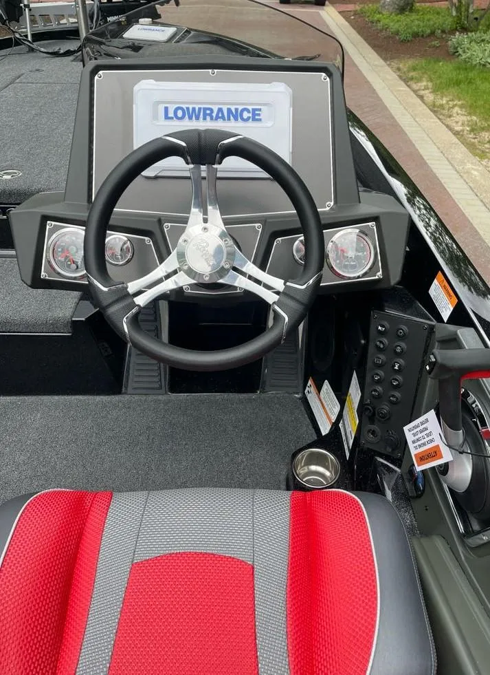 Slide: The Image of 2025 Ranger Z518 boat dashboard with Lowrance display and red seat. - 4