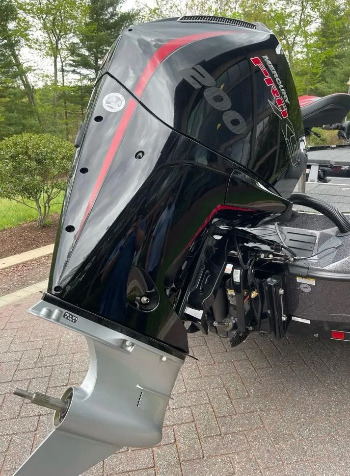 Slide: The Image of 2025 Ranger Z518 boat with a powerful 200 horsepower outboard motor, parked on a brick driveway. - 7