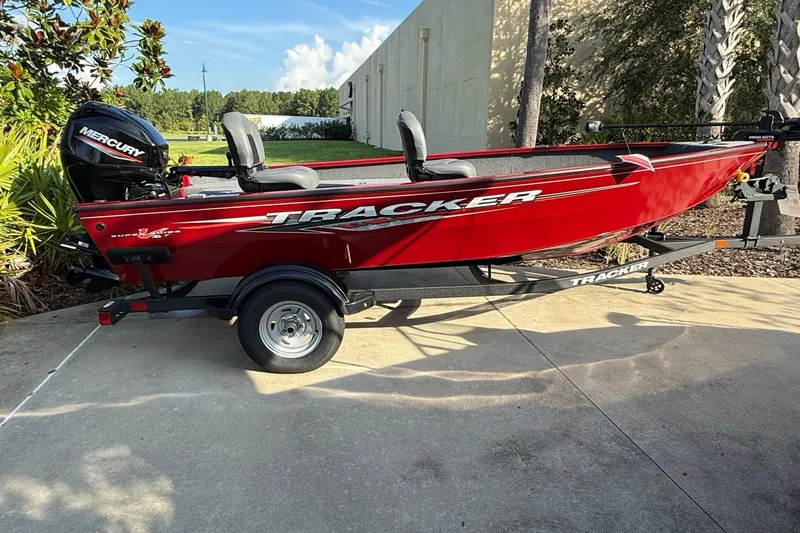 The Image of 2025 Tracker Super Guide V-16 T boat, red, on trailer, with Mercury engine. - 0