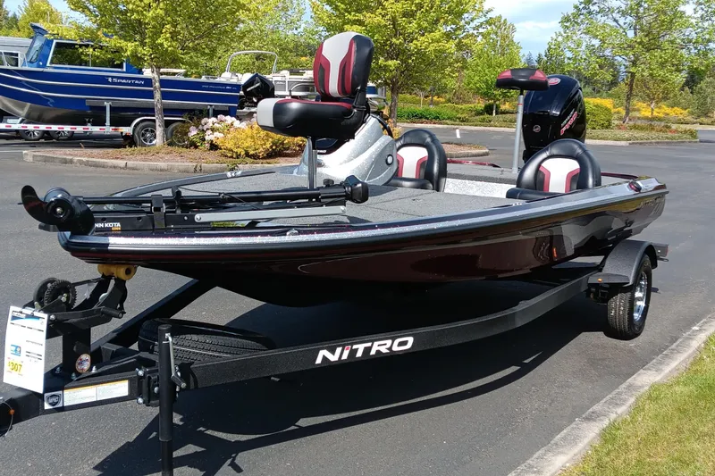 Slide: The Image of 2025 Nitro Z17 fishing boat on trailer, parked outdoors, featuring sleek design and modern seating. - 0