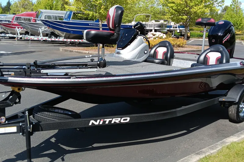 Slide: The Image of 2025 Nitro Z17 boat on trailer, parked outdoors, with seating and motor visible. - 2
