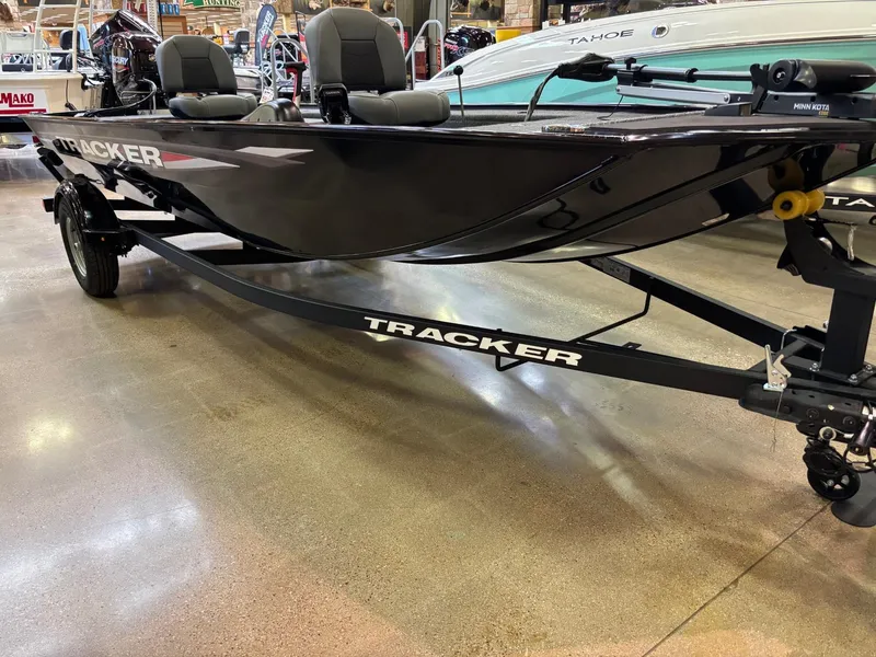 Slide: The Image of 2025 Tracker Panfish 17 boat interior with cushioned seating and control panel. - 2