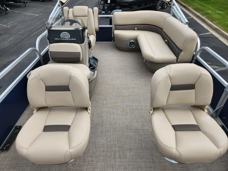 Slide: The Image of 2025 Sun Tracker Bass Buggy 16 XL Select pontoon boat with beige seating and spacious layout. - 2